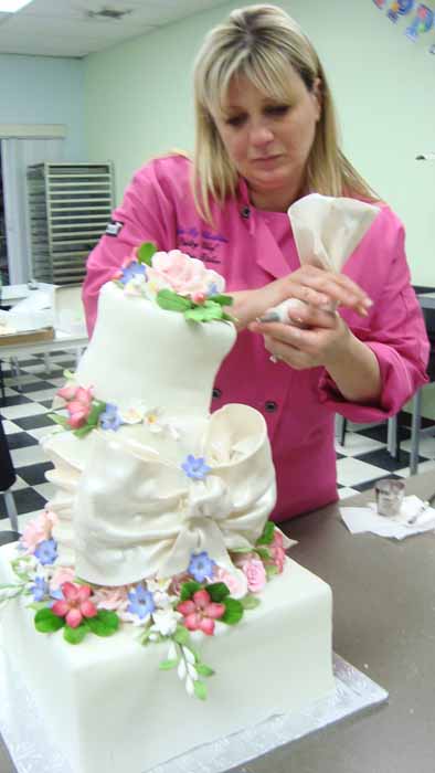 Woman decorating wedding cake