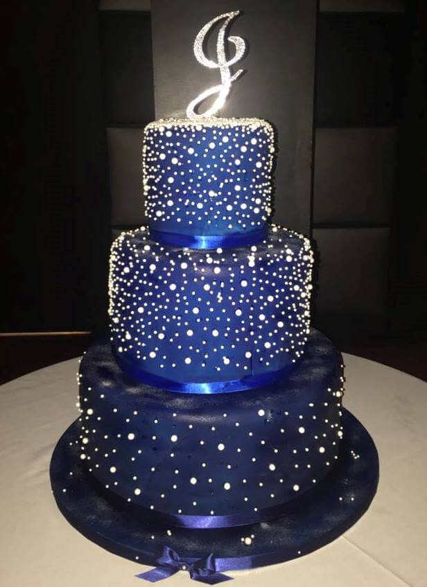 3-tiered navy blue cake with "J" on top
