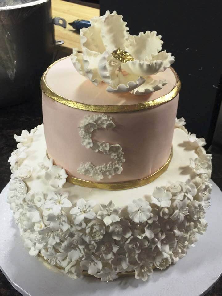 white and pink cake with white flowers