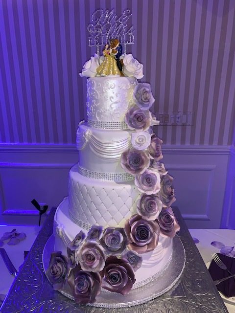 White 4-tiered cake with purple flowers