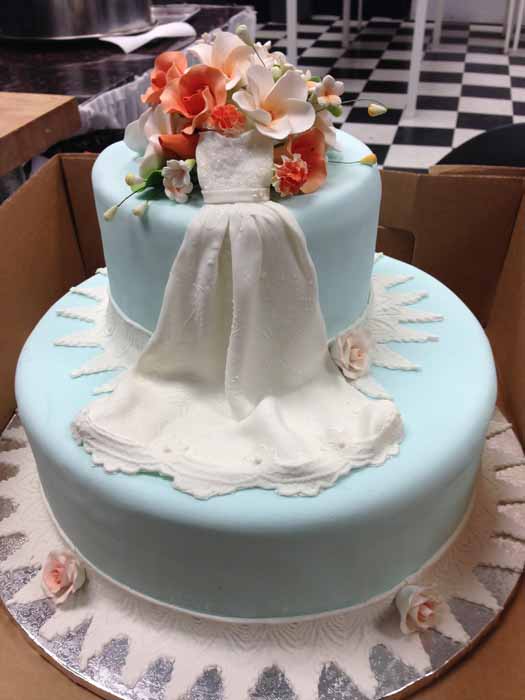 light blue 2-tiered cake with wedding dress