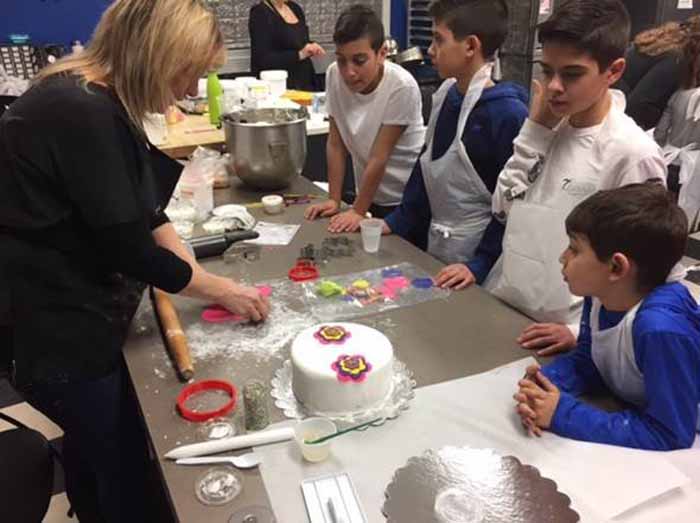 4 boys listening in cake class